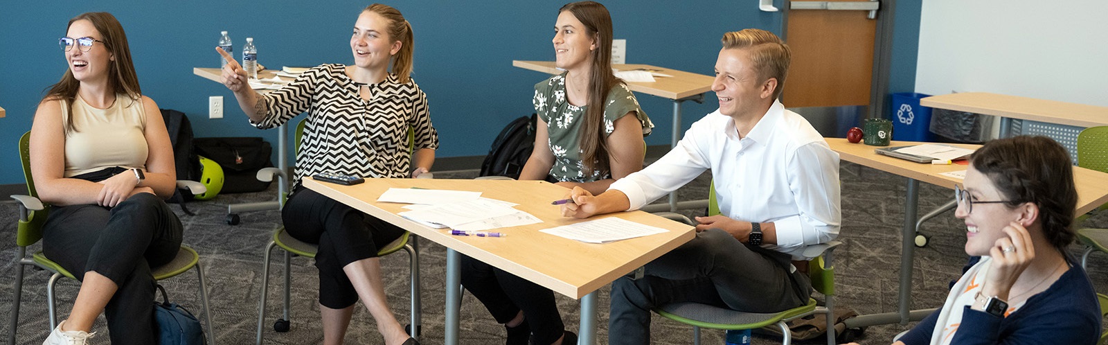 Fivestudentsinclassroomlaughingandtalking