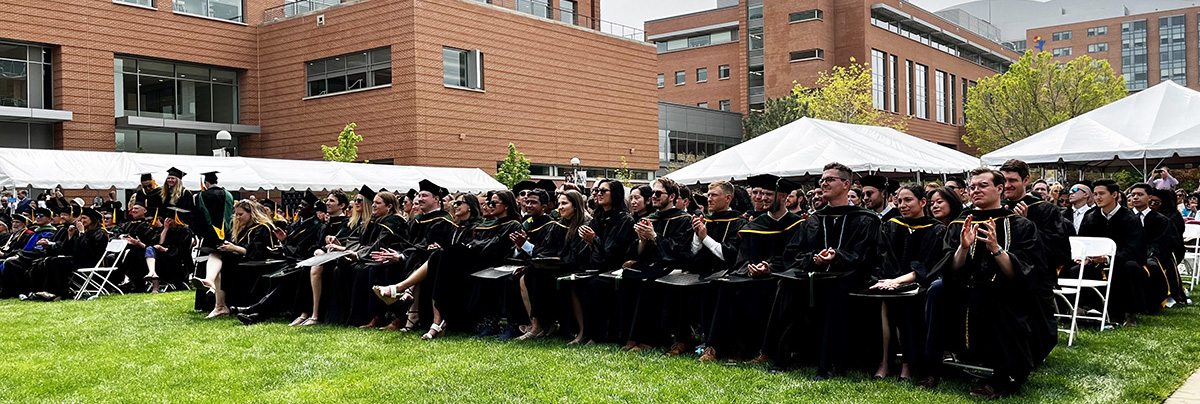 Graduates seated on the green
