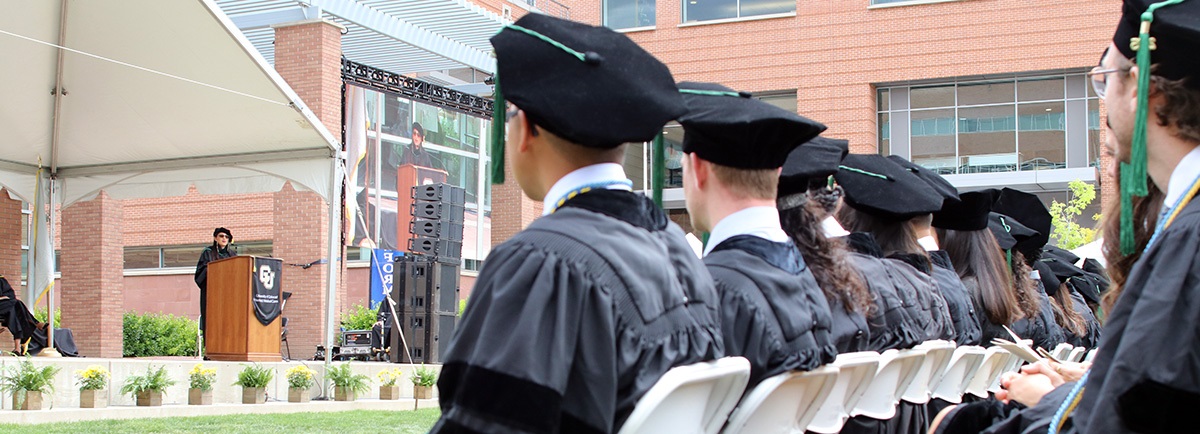 lowofgraduatesseatedwatchingstage