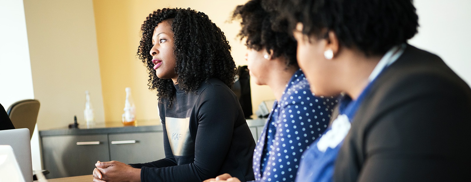 threewomenseatedfromprofile