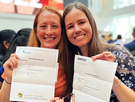 TwostudentsatMatchDayholdingtheirletters