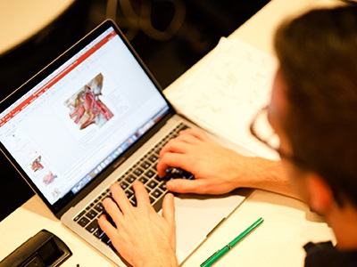 studentatlaptoplookingatagraphicoftheinsideofahumanskull