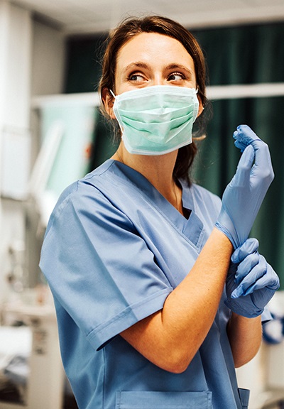 studentwearingmaskputtingongloves