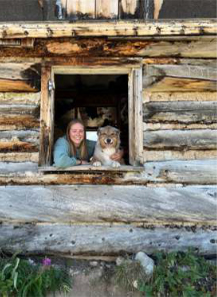 Madeleine Mason in a log cabin