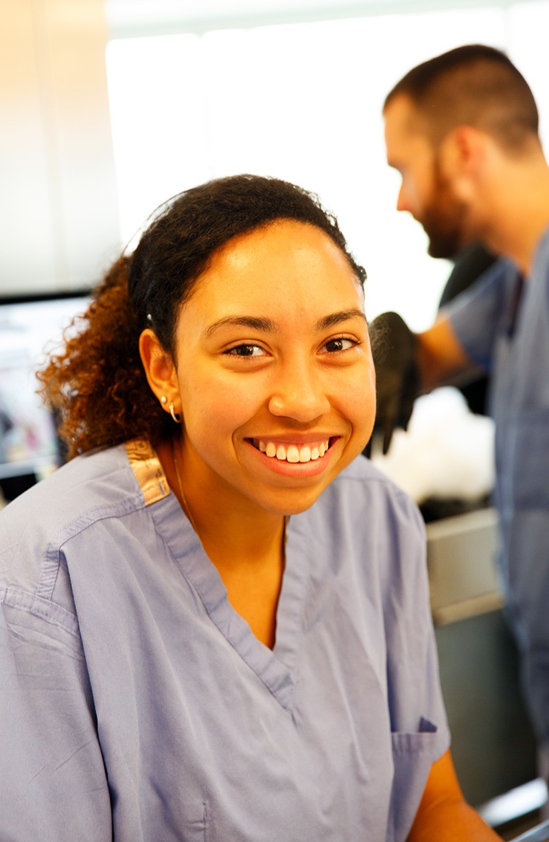 Studentwearingscrubssmilingatcamera