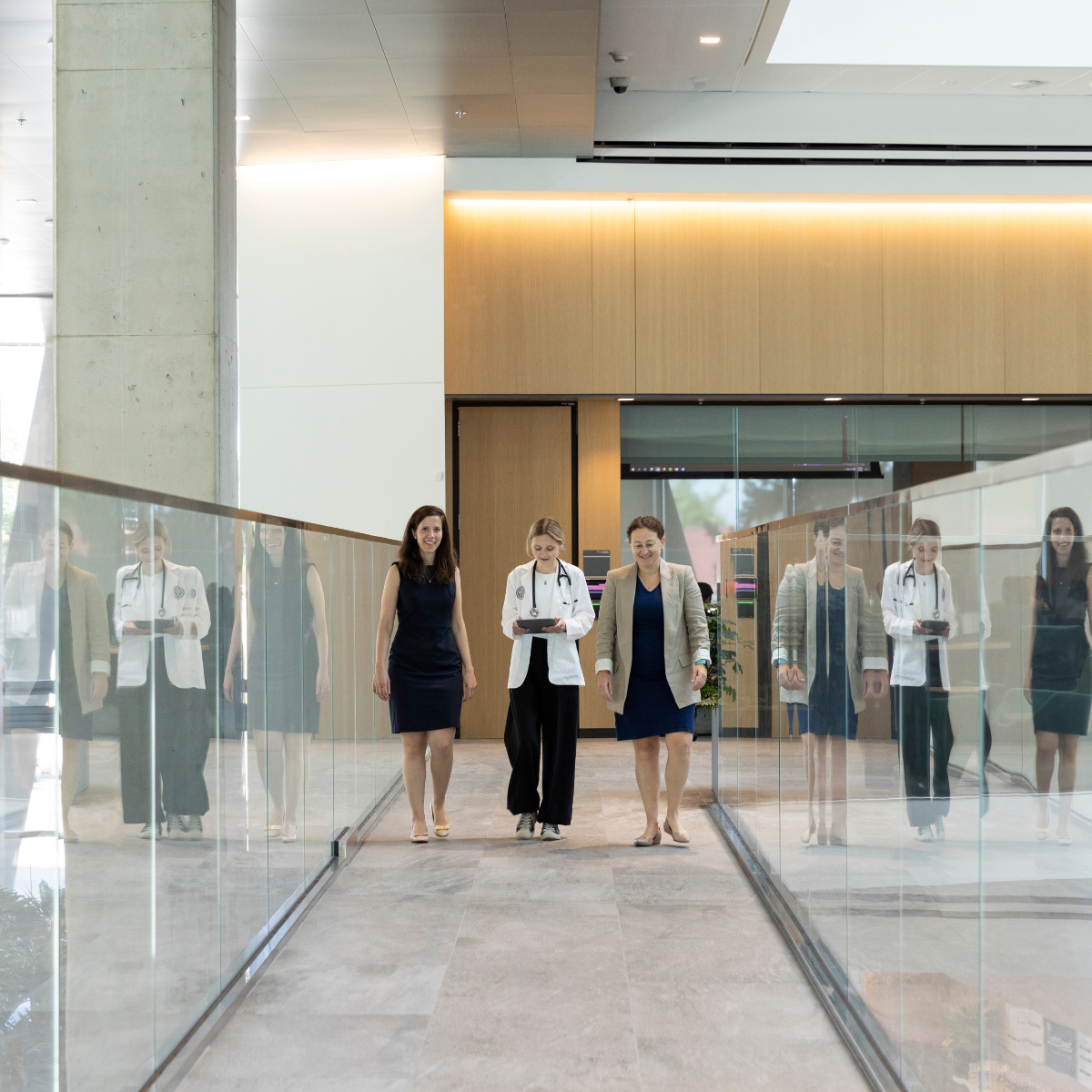 womenwalkinglasshallway