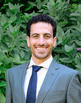 Man with curly hair smiling