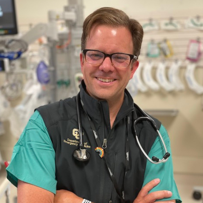 DoctorinscrubsandCUvestwithstethoscopesmiling