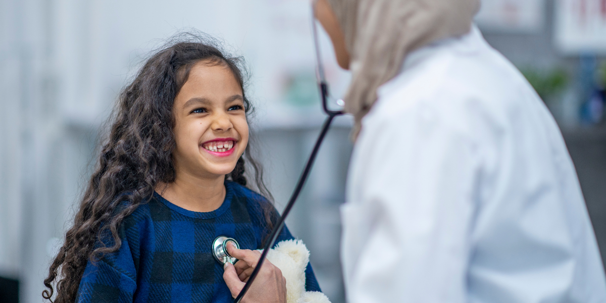 Girlsmileswhiledoctorchecksherheart