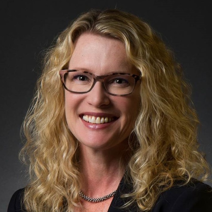 womanwithcurlyhairandblacksuitjacket