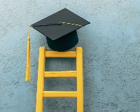 Graduation cap sitting on a ladder