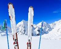 Skis and poles standing upright in snowy mountain landscape