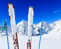 Skis and poles standing upright in snowy mountain landscape