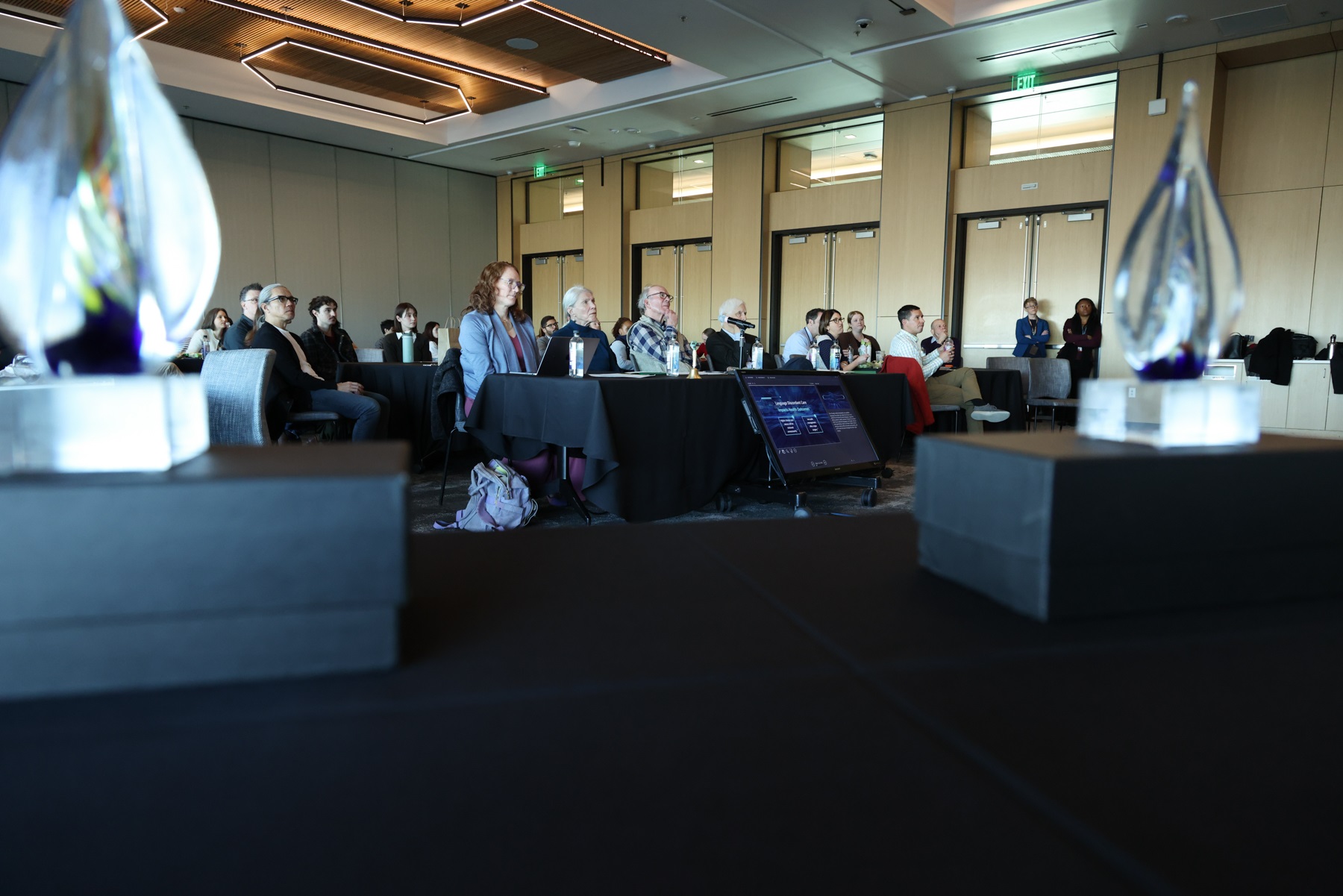 KeyholeimageofpanelofjudgesseenbetweentwoSparkTanktrophies