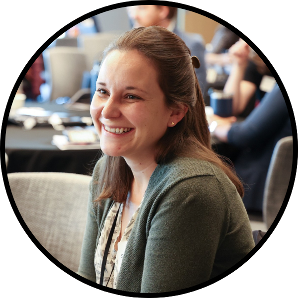 Womanconversingatatableatthesymposium