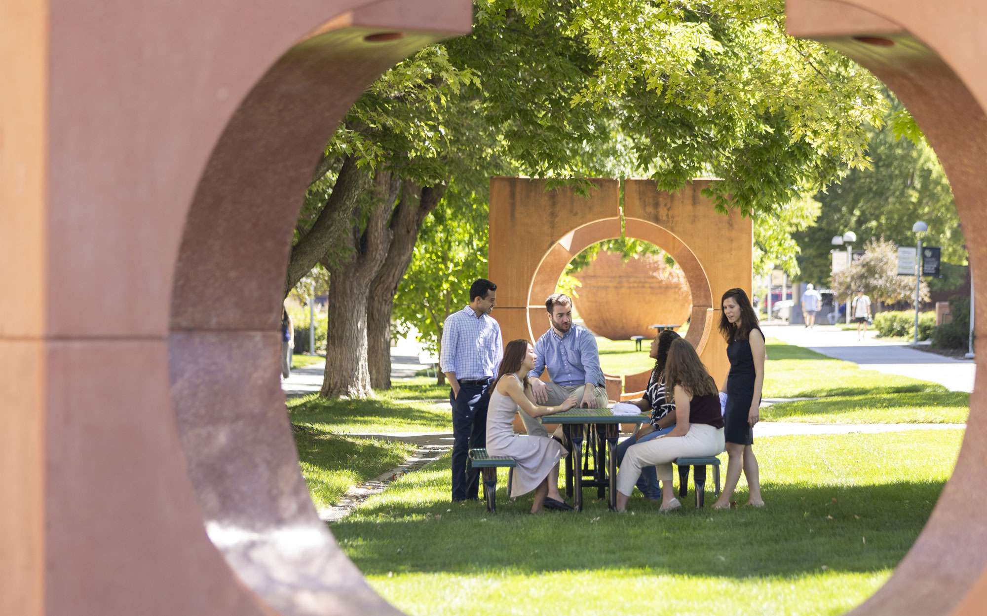 Students and faculty meeting outdoors on campus