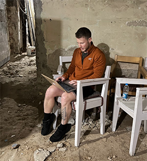 dave young taking notes in bombed out shelter