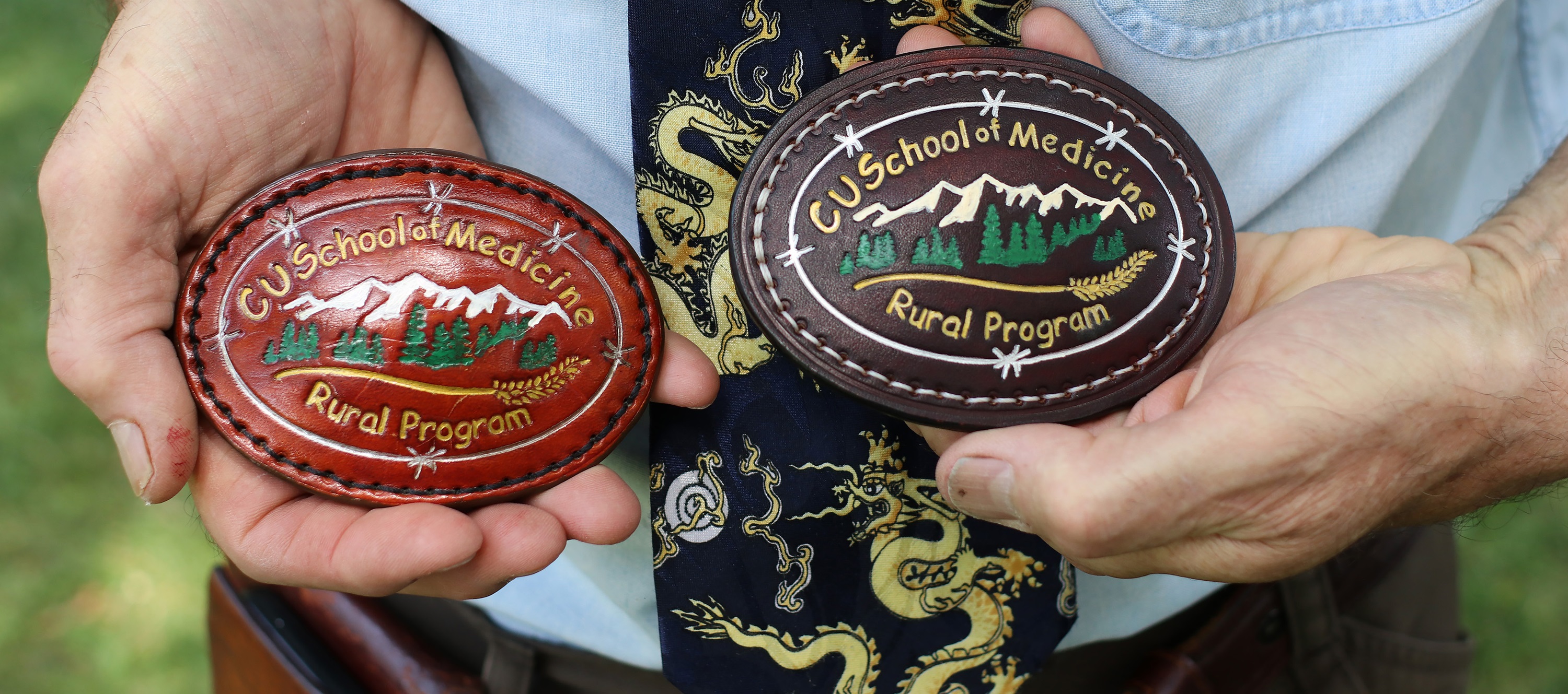 Deutchmanholdingbeltbucklesmadeforhisruralclasses