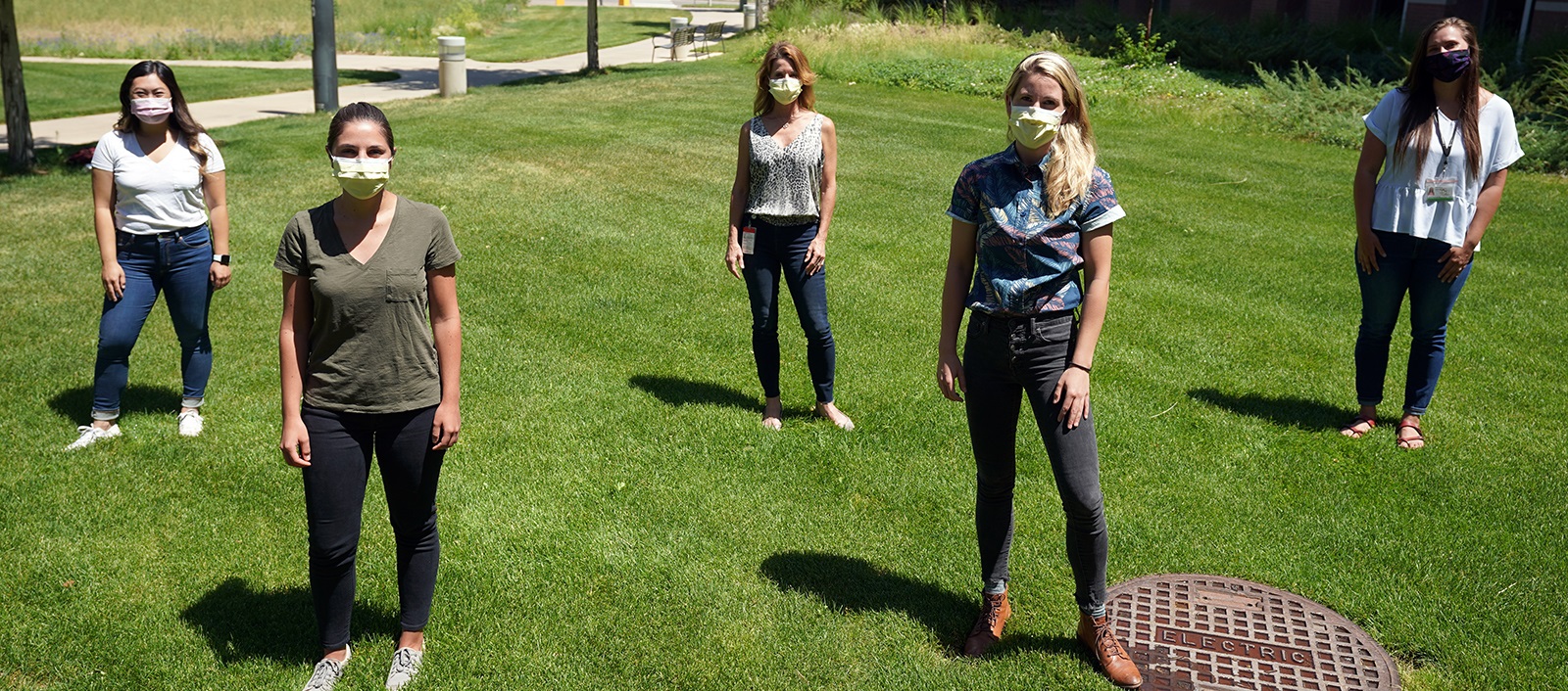 medicalstudentswearingmasksandstandingongrasssixfeetapart