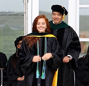 graduatebeinghoodedonstage