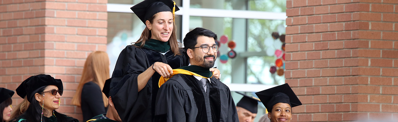 studentbeinghoodedonstage