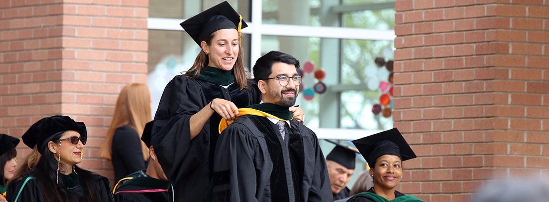 graduatebeinghoodedonstage