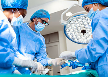 Surgeons, three, in operating room
