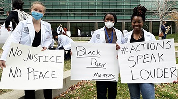 studentsholdingsignsonresearchquad