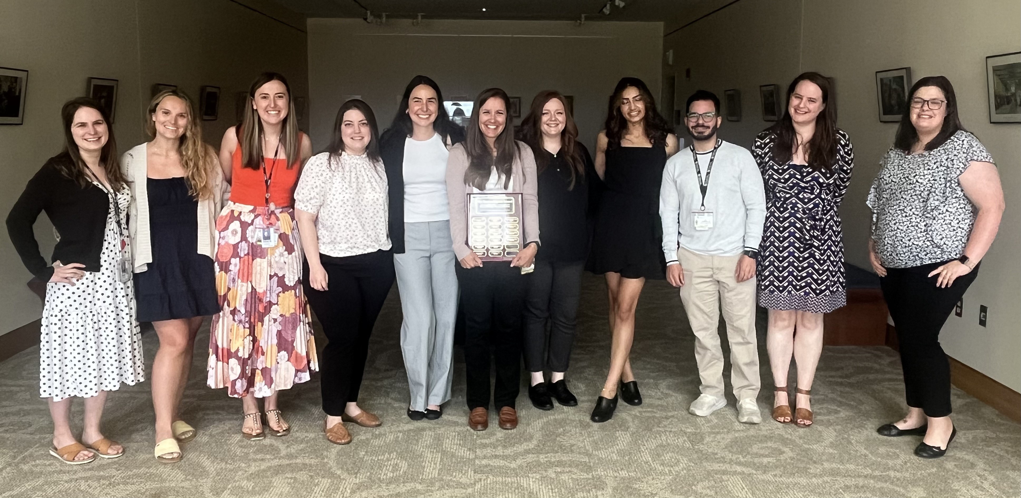 Marisa Kostiuk, PhD posing with fellows and award