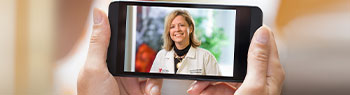 Photo of a person having a virtual visit with a doctor via smartphone