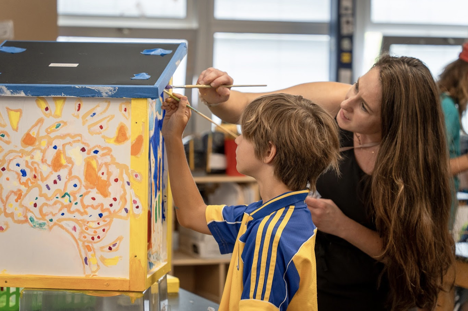 Teacher with child painting