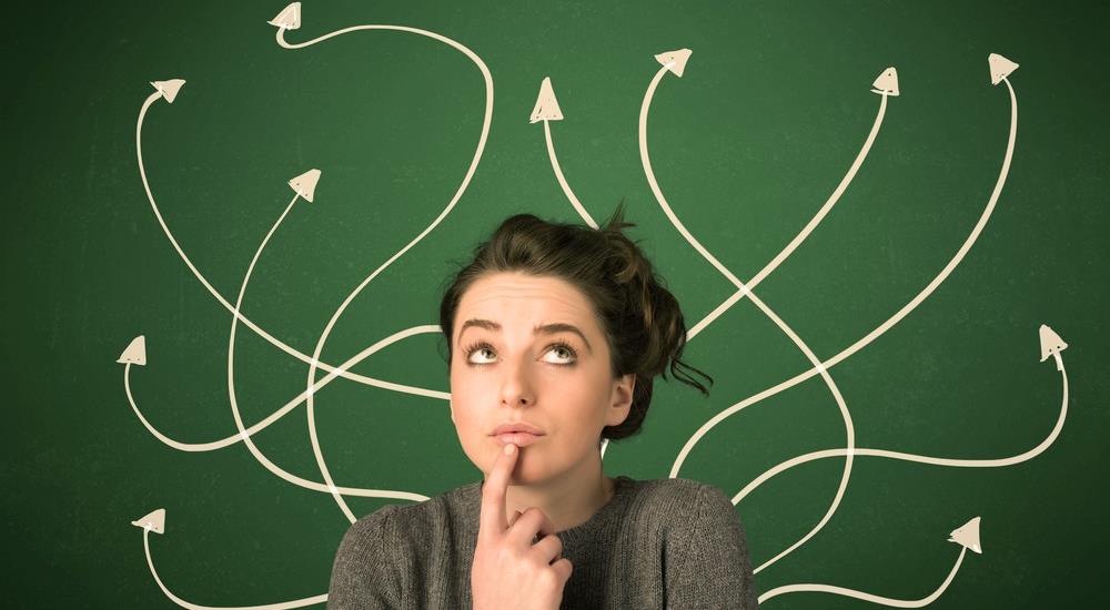 Girl thinking while multiple arrows point in different directions behind her