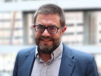 Man in blue suit and glasses