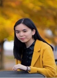 headshot of woman in yellow blazer