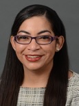 Headshot of a woman with glasses and dark hair