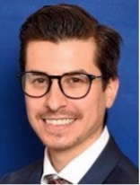 Headshot of a man with glasses in a collared shirt and tie