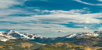 view of mountain tops and clouds