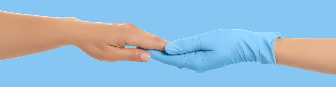 two hands touching, one in a blue latex glove