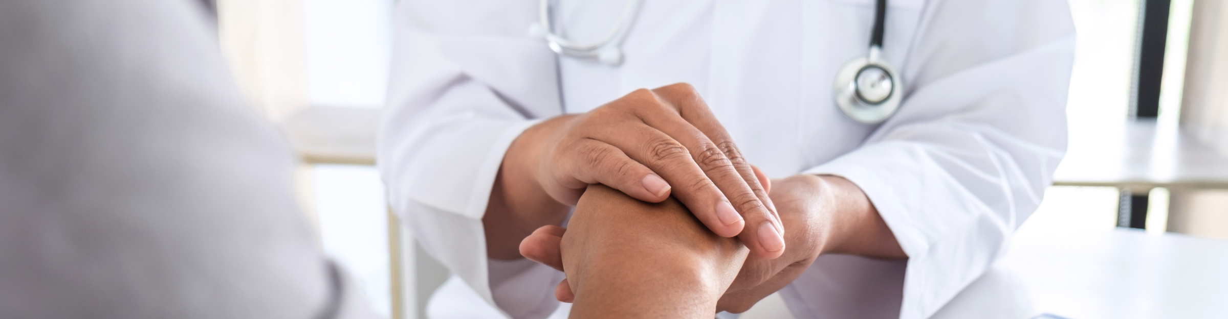 doctor holding patient's hand