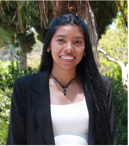 Woman in white shirt and black graduation robe