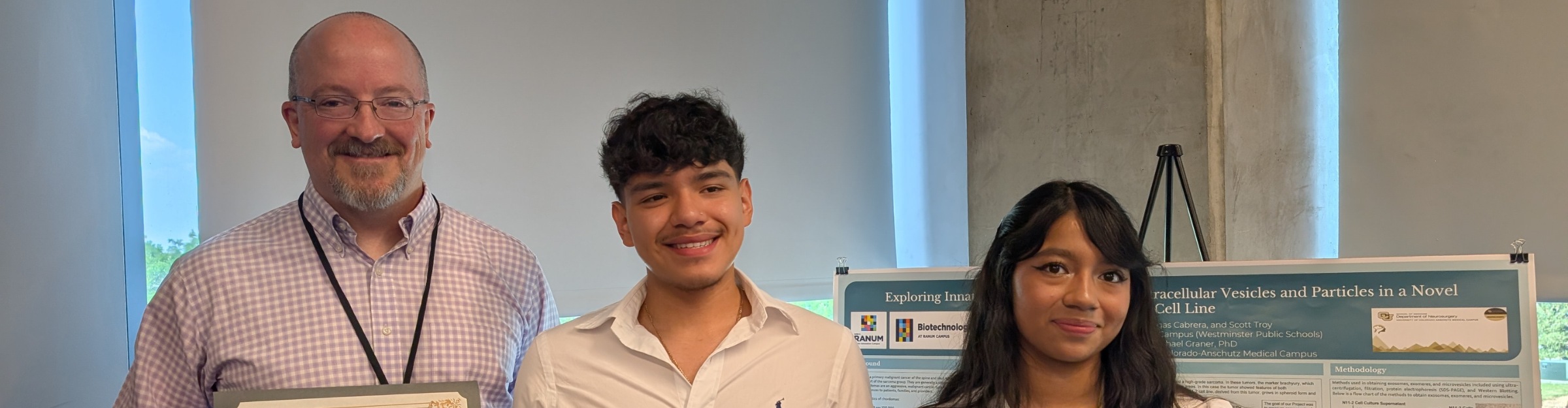 Teacher and students smile for award