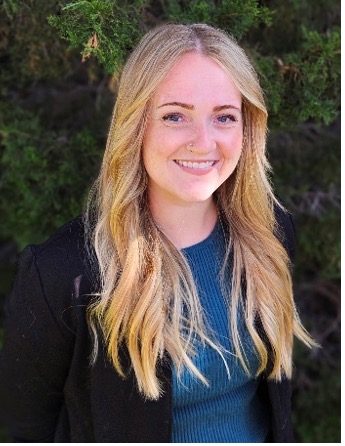 blonde woman in a blue shirt with a black blazer