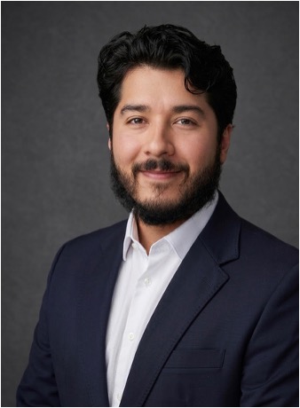 man in a black suit with a crisp white shirt