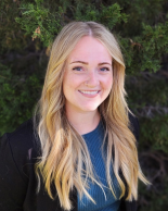 Blonde woman in blue shirt and black blazer
