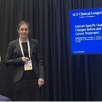 Brunette woman in a ponytail and black blazer