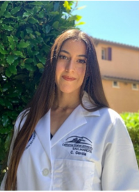Brunette woman in white coat