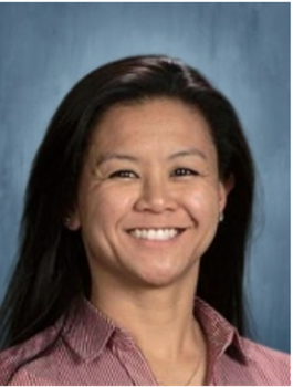 Woman with black hair in a mauve collared shirt