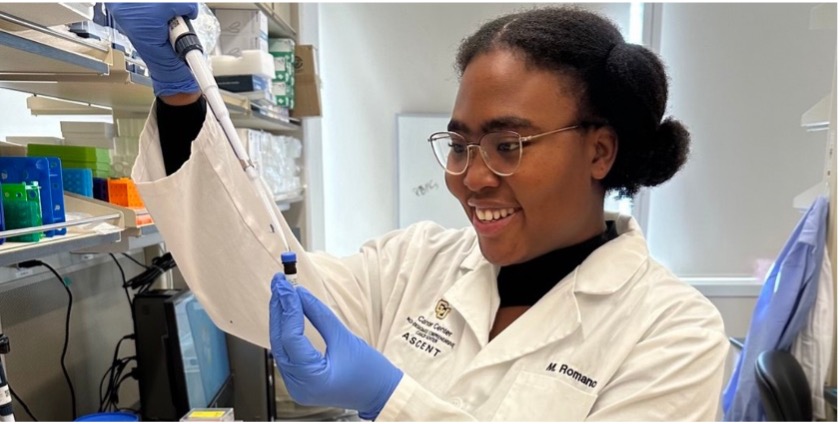 Black woman measures with a pipette