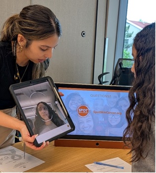 woman displaying tablet across table