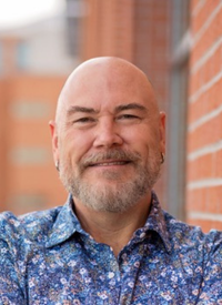 Bald man in a patterned shirt